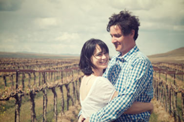 Photo of owners, Kyle and Amy Johnson in vineyard